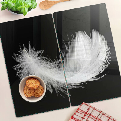 Glass kitchen board Feather on black background