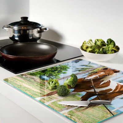 Glass chopping board A horse with palm trees in the background