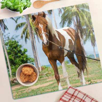 Glass chopping board A horse with palm trees in the background