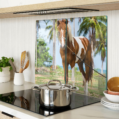 Glass chopping board A horse with palm trees in the background