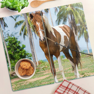 Glass chopping board A horse with palm trees in the background