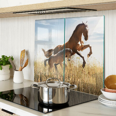 Glass kitchen board Horses in a meadow in the sun
