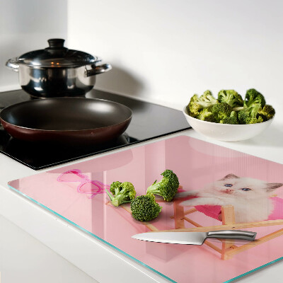 Glass chopping board Kitten on a deckchair on a pink background