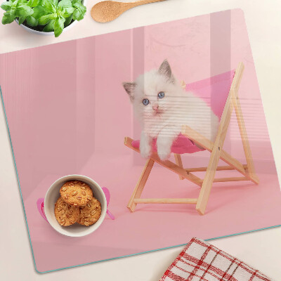 Glass chopping board Kitten on a deckchair on a pink background