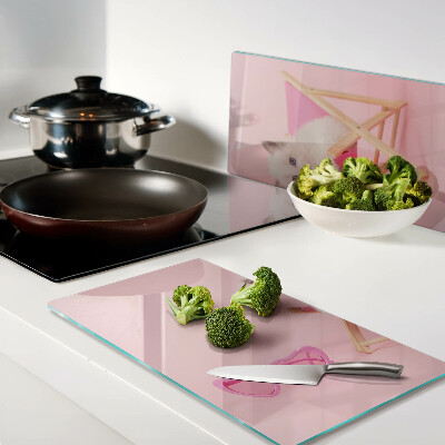 Glass chopping board Kitten on a deckchair on a pink background