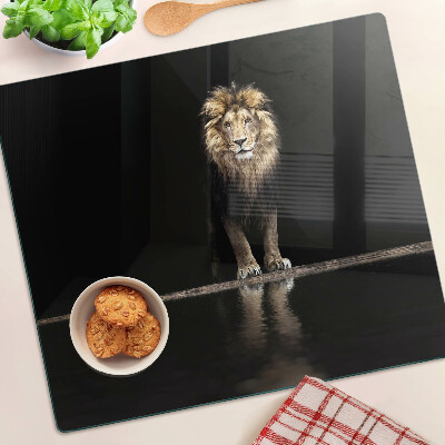 Glass kitchen board Lion on a dark background
