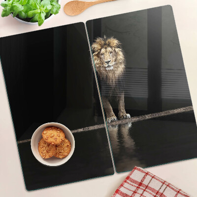 Glass kitchen board Lion on a dark background