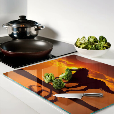 Glass chopping board A horse against the backdrop of the setting sun