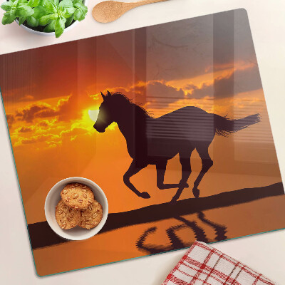 Glass chopping board A horse against the backdrop of the setting sun