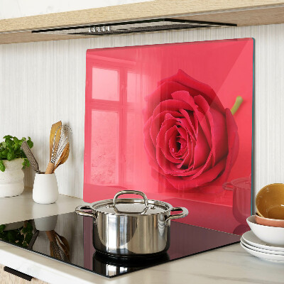 Glass chopping board Red rose on the background