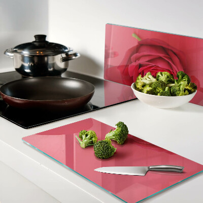 Glass chopping board Red rose on the background