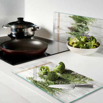 Glass chopping board Herbs on a wooden background