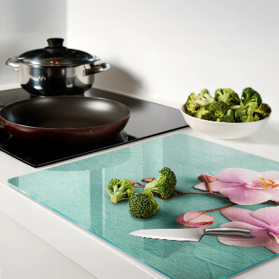 Glass kitchen board Orchids on a blue background