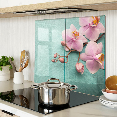 Glass kitchen board Orchids on a blue background