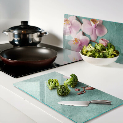 Glass kitchen board Orchids on a blue background