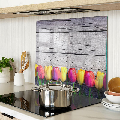 Glass chopping board Tulips on a wooden background