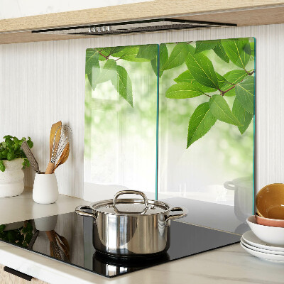 Glass chopping board Leaves against a background of blurred green