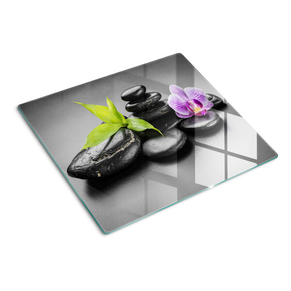 Glass kitchen board Stones and orchid on the background