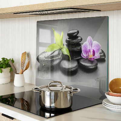 Glass kitchen board Stones and orchid on the background