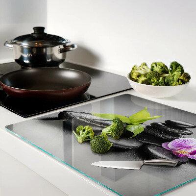 Glass kitchen board Stones and orchid on the background