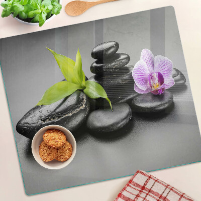 Glass kitchen board Stones and orchid on the background