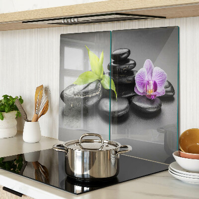 Glass kitchen board Stones and orchid on the background