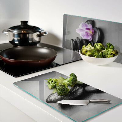 Glass kitchen board Stones and orchid on the background