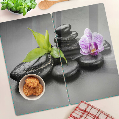 Glass kitchen board Stones and orchid on the background