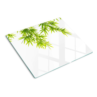 Glass chopping board Bamboo leaves on the window background