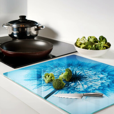 Glass chopping board Dandelion on a blue background