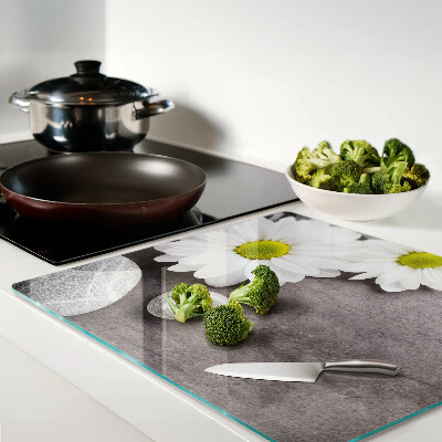 Glass chopping board Flowers and stones on the background
