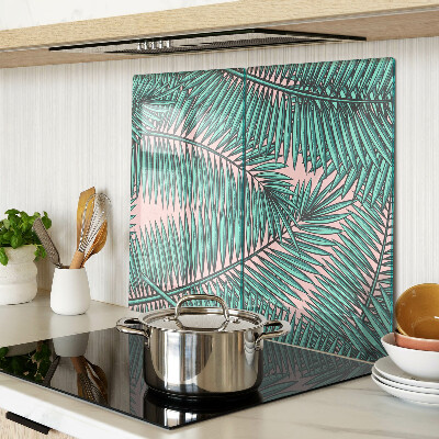 Glass kitchen board Palm leaves on a pink background