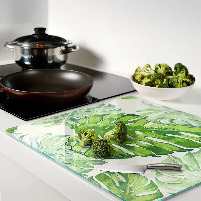Glass kitchen board Monstera leaves on a light background