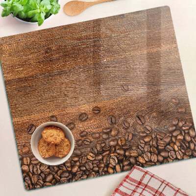 Glass chopping board Coffee beans on wooden background