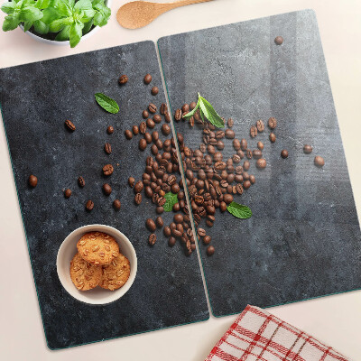 Glass chopping board Coffee beans on a stone background