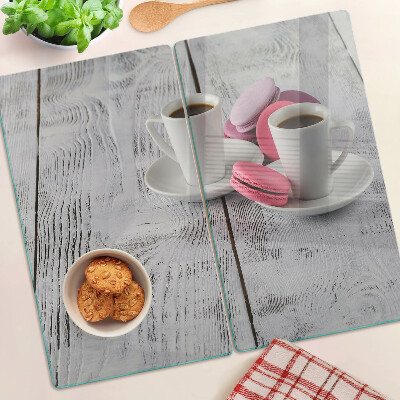 Glass chopping board Coffee and macaroons on a wooden background