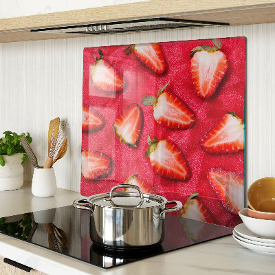 Glass chopping board Strawberries on a pink background