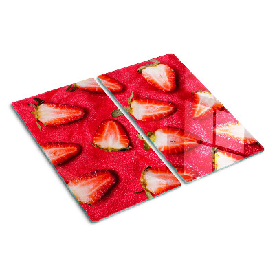 Glass chopping board Strawberries on a pink background