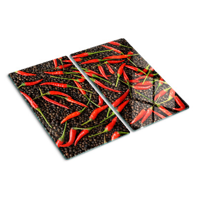 Glass chopping board Chili peppers on black pepper