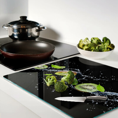 Glass chopping board Kiwi in water with leaves