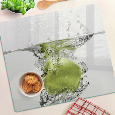 Glass chopping board Green apple in water