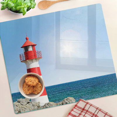 Glass kitchen board Lighthouse over the ocean