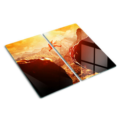 Glass kitchen board Jumping in the mountains at sunset