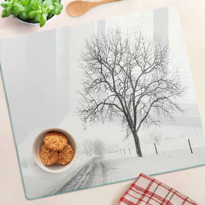 Glass kitchen board Empty winter landscape with a tree
