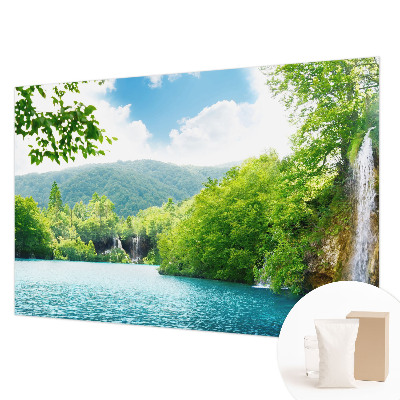 Large wallpaper mural featuring a natural waterfall scene