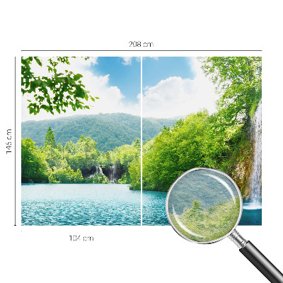 Large wallpaper mural featuring a natural waterfall scene