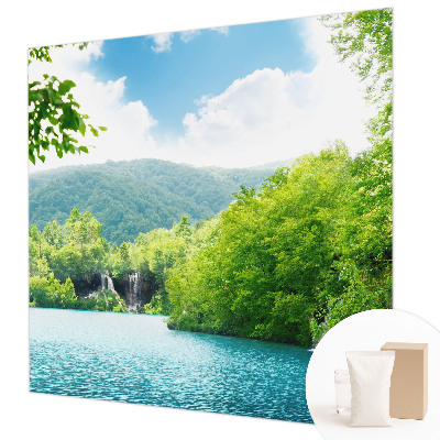 Large wallpaper mural featuring a natural waterfall scene