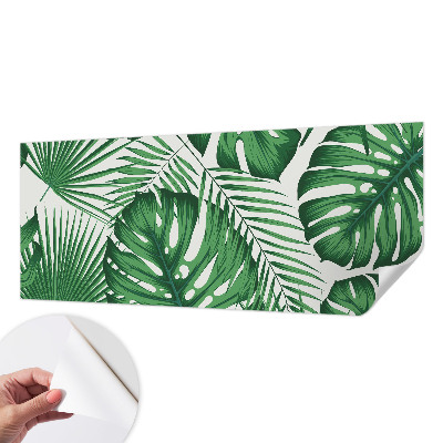 Removable wall mural with a tropical leaves design
