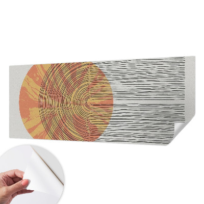 Stick-on wall mural with a circular motif and linear accents