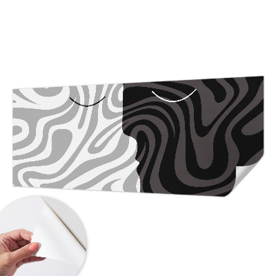 Stick-on wall mural with an abstract faces design